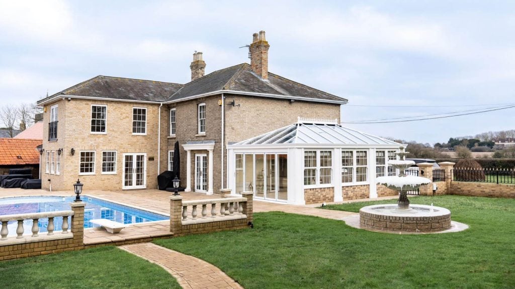 Big house with sliding sash windows, French doors, conservatory and a swimming pool