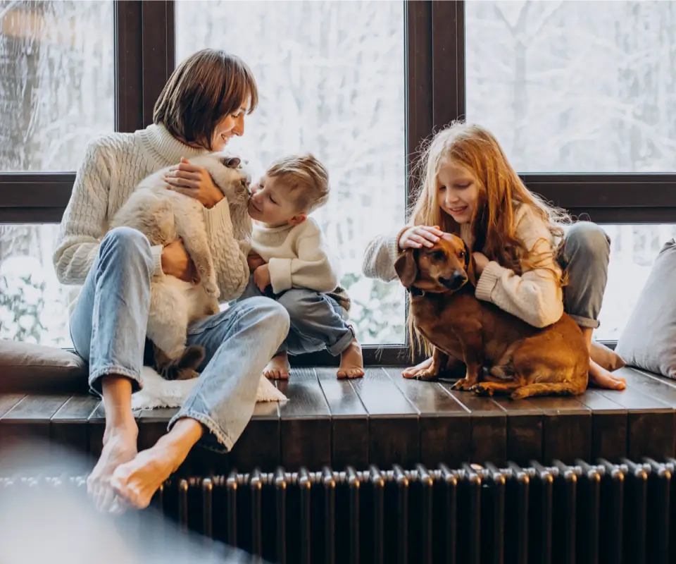 Family sitting on a window cill with a wintery background